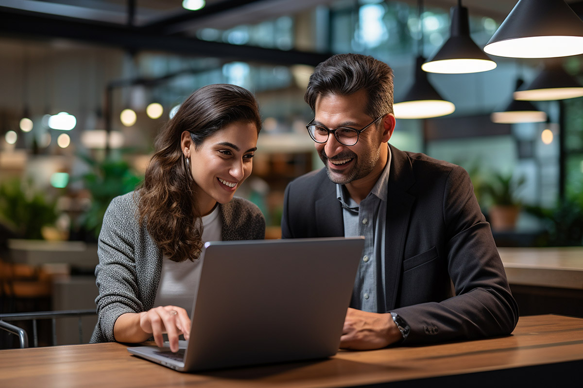 Two professionals collaborating on a laptop in a modern workspace, emphasizing teamwork and digital marketing strategies, relevant to Myrtle SEO's focus on tailored SEO solutions.